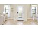 Bright entryway with tile flooring, white door, and natural light at 20391 Lagente Cir, Venice, FL 34293