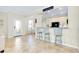 Open concept kitchen with breakfast bar and view of entryway at 20391 Lagente Cir, Venice, FL 34293
