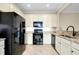 Modern kitchen featuring black appliances and granite countertops at 20391 Lagente Cir, Venice, FL 34293