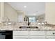 Kitchen with granite countertops, black appliances and a breakfast bar at 20391 Lagente Cir, Venice, FL 34293