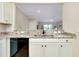 Kitchen with granite countertops, black appliances, and a breakfast bar at 20391 Lagente Cir, Venice, FL 34293