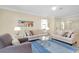 Bright living room with comfy sofas, coffee table, and stylish rug at 20391 Lagente Cir, Venice, FL 34293