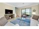 Living room with TV, seating area, and view of backyard at 20391 Lagente Cir, Venice, FL 34293