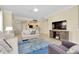 Open living space featuring a TV, comfortable seating, and view into kitchen at 20391 Lagente Cir, Venice, FL 34293