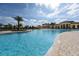 Resort-style pool with a large deck and clubhouse in the background at 20391 Lagente Cir, Venice, FL 34293