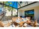 Relaxing screened patio with lake view and seating area at 20391 Lagente Cir, Venice, FL 34293