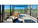 Spacious screened patio with table and chairs, overlooking a lake at 20391 Lagente Cir, Venice, FL 34293