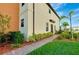 Neatly landscaped side yard with a brick pathway leading to the back at 20391 Lagente Cir, Venice, FL 34293