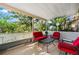 Screened porch with red furniture and backyard access at 2151 Broom Ct, Port Charlotte, FL 33952