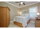 Cozy bedroom with wood furniture and window with plantation shutters at 275 Cassano Dr, Nokomis, FL 34275