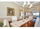 Elegant dining room with a wood table, neutral decor, and a chandelier at 275 Cassano Dr, Nokomis, FL 34275