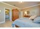 Elegant bedroom with ensuite bathroom access and a large wooden armoire at 275 Cassano Dr, Nokomis, FL 34275