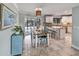 Bright dining area with table and chairs, opening to kitchen and pool at 320 Gaugin Dr, Osprey, FL 34229