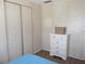 Corner bedroom features laminate flooring, a dresser, and built-in wardrobe for maximized storage at 359 Longwood Dr, Venice, FL 34285