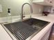 Stainless steel kitchen sink with modern faucet and stylish accessories at 4213 Vicenza Dr # D2, Venice, FL 34293