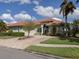 House exterior featuring a brick driveway and lush landscaping at 4245 Via Del Villetti Dr, Venice, FL 34293