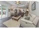 Spacious living room with comfortable seating and access to the backyard patio at 4245 Via Del Villetti Dr, Venice, FL 34293