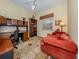 Home office features built-in shelving, desk, and comfortable seating at 4245 Via Del Villetti Dr, Venice, FL 34293