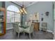 Dining room with a glass-top table and modern chandelier at 4245 Via Del Villetti Dr, Venice, FL 34293