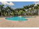 Inviting kidney-shaped pool with palm trees and lounge chairs at 4245 Via Del Villetti Dr, Venice, FL 34293