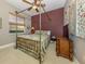 Bedroom with canopy bed and rich colored accent wall at 4245 Via Del Villetti Dr, Venice, FL 34293