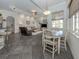 Open concept kitchen and dining area with dark tile flooring at 4245 Via Del Villetti Dr, Venice, FL 34293