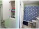 Bathroom with shower/tub combo, linen closet, and geometric patterned shower curtain at 428 Boxwood Dr, Venice, FL 34285