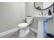 Clean and modern powder room with pedestal sink and white toilet at 569 Mistiflower Cir, Nokomis, FL 34275