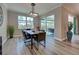 Bright dining room features a wood table and chairs, recessed lighting, and sliding glass doors at 569 Mistiflower Cir, Nokomis, FL 34275