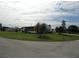 White mobile home with green lawn and street view at 6234 Parakeet Rd, Englewood, FL 34224