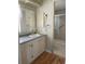 Well-lit bathroom with vanity, mirror, and tiled shower at 6234 Parakeet Rd, Englewood, FL 34224