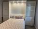 Bright bedroom with a unique murphy bed/closet and built in lights and shelving at 6234 Parakeet Rd, Englewood, FL 34224