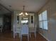 Cozy dining room with stylish lighting fixture and wood-look flooring at 6234 Parakeet Rd, Englewood, FL 34224