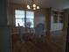 Open dining area with hardwood floors, glass-topped table, and traditional wicker chairs at 6234 Parakeet Rd, Englewood, FL 34224