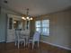 Bright dining room with mirrored built-in hutch, glass-topped table, and wicker chairs at 6234 Parakeet Rd, Englewood, FL 34224