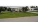 Charming single-story home with a well-maintained lawn, mature trees, and lovely landscaping at 6234 Parakeet Rd, Englewood, FL 34224