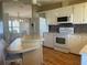 Open-concept kitchen features white appliances, mosaic backsplash, and dining area at 6234 Parakeet Rd, Englewood, FL 34224