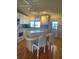 Kitchen area with white cabinets, a dining island, and natural light at 6234 Parakeet Rd, Englewood, FL 34224