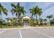 Community clubhouse with palm trees and ample parking at 648 Lakescene Dr, Venice, FL 34293