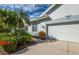 Front view of a house with palm trees and well-manicured landscaping at 649 Crossfield Cir # 10, Venice, FL 34293