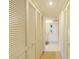 Hallway with built-in storage and access to bathroom at 984 Bird Bay Way # 255, Venice, FL 34285