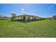 House with a large grassy yard and mature landscaping at 1402 Grand Blvd # 240, Sarasota, FL 34232