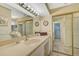 Bathroom boasting double sinks and mirrored closet doors at 1402 Grand Blvd # 240, Sarasota, FL 34232