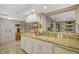 Bright kitchen features granite countertops, white cabinets, and a double sink at 1402 Grand Blvd # 240, Sarasota, FL 34232