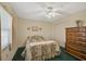 Bedroom with double bed, dresser, and ceiling fan at 1402 Grand Blvd # 240, Sarasota, FL 34232