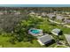 Community pool with lounge chairs and landscaping at 1402 Grand Blvd # 240, Sarasota, FL 34232