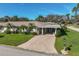 Single-story home with carport, lush landscaping, and a mailbox at 1402 Grand Blvd # 240, Sarasota, FL 34232