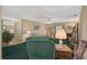 Bright living room featuring green carpeting and comfortable seating at 1402 Grand Blvd # 240, Sarasota, FL 34232