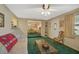 Living room with green carpet, sofa and access to other rooms at 1402 Grand Blvd # 240, Sarasota, FL 34232