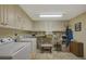 Laundry room with washer, dryer, and ample cabinet space at 1402 Grand Blvd # 240, Sarasota, FL 34232